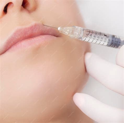Premium Photo | Woman receiving a botox injection in her lips close upxaxa