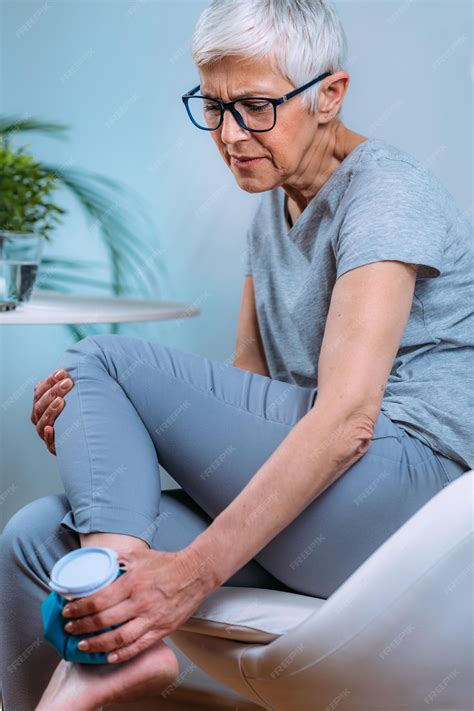 Premium Photo | Ankle pain treatment senior woman holding ice bag