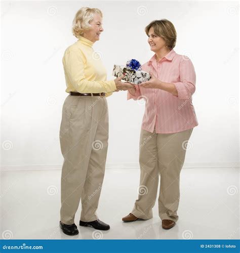 Woman Giving Gift To Friend. Stock Photo - Image of people, present