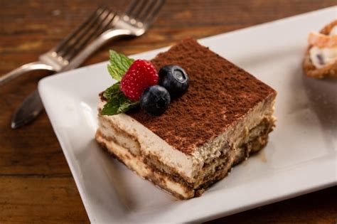 Premium Photo | Traditional italian desserts tiramisu and cannoli on ...
