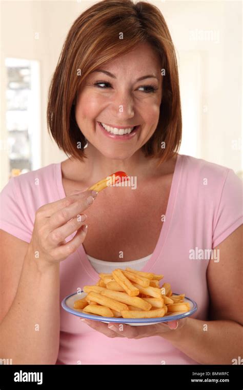 WOMAN EATING FRENCH FRIES Stock Photo - Alamy