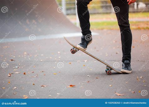 Close-up of a Skateboarder`s Foot in an Autumn Skate Park. Stock Image ...