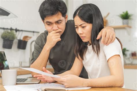 Stressed asian young couple family, wife and husband confused by