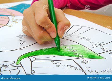 Girl Drawing with a Green Crayon in Classroom Stock Image - Image of ...