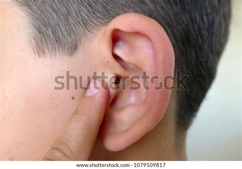 scratching ear finger ear diseases ear stock photo edit