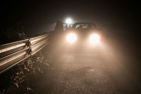 bright lights   car driving   dark road  stock photo