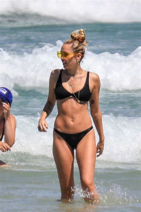 miley cyrus enjoying the beach in a black bikini in byron bay ...