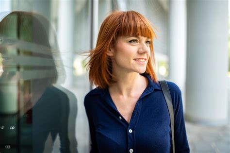 premium photo confident young redhead female manager outdoor