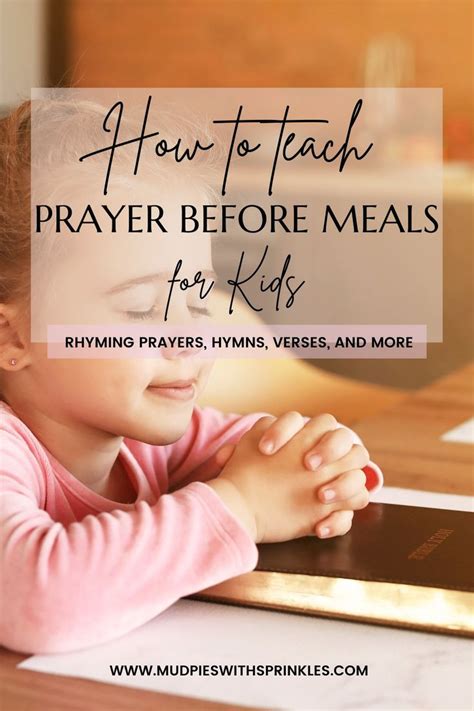 A little girl praying with her hands folded together. Her hands resting ...