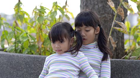 Slow motion shot, Close up Asian little sister tried to sit on her