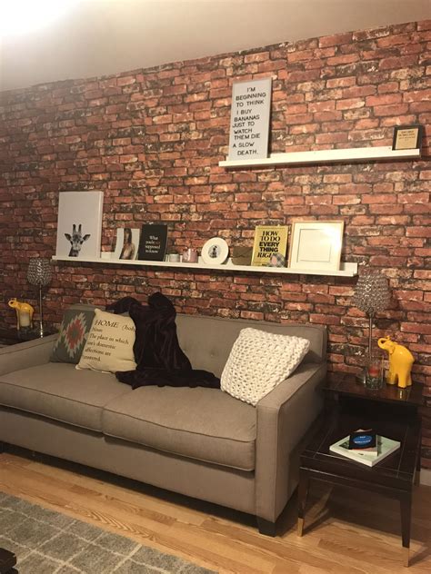 picture ledge brick wall grey couch and color accents living room Brick ...