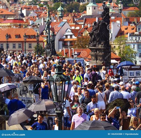 Many Tourists Walk by the Charles Bridge in Prague Editorial Stock