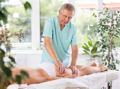 skilled  masseur conducting hip massage  woman client stock photo