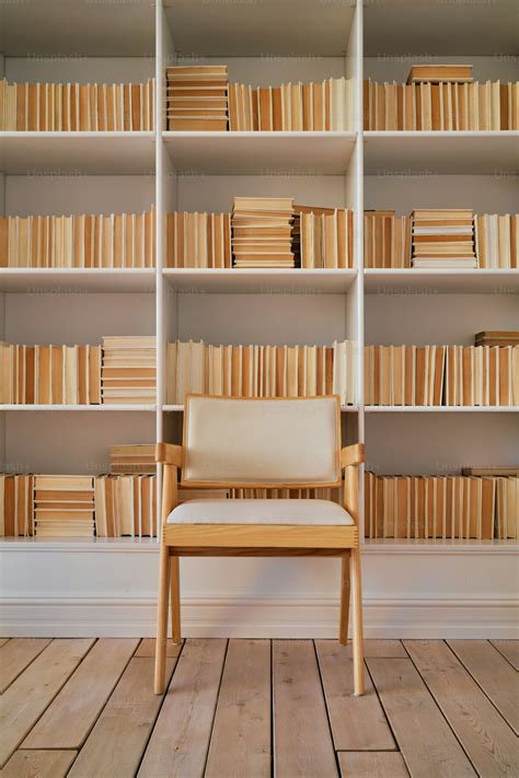 chair sitting  front   book shelf filled  books photo