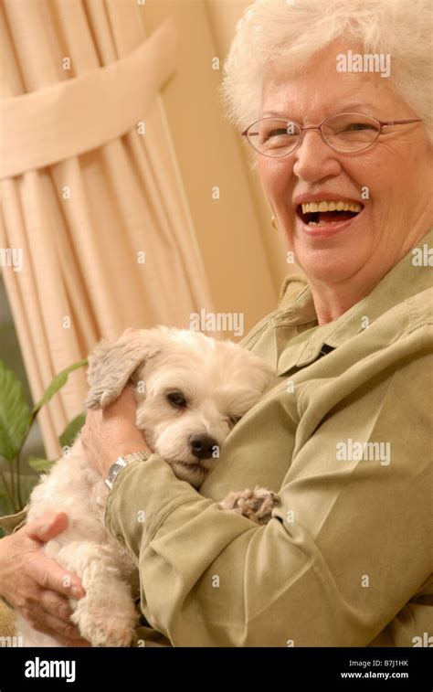 Senior Woman with white dog, Regina, Saskatchewan Stock Photo - Alamy