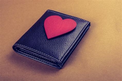 premium photo red heart  wallet  hand saving  finance concept