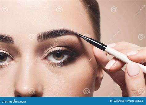 artist apply eyebrow shadow  brush beauty stock photo