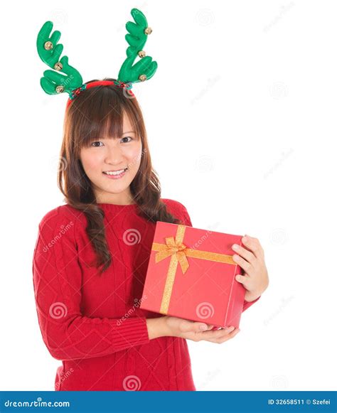 Asian Christmas Woman Holding Gift Wearing Reindeer Horns. Stock Image