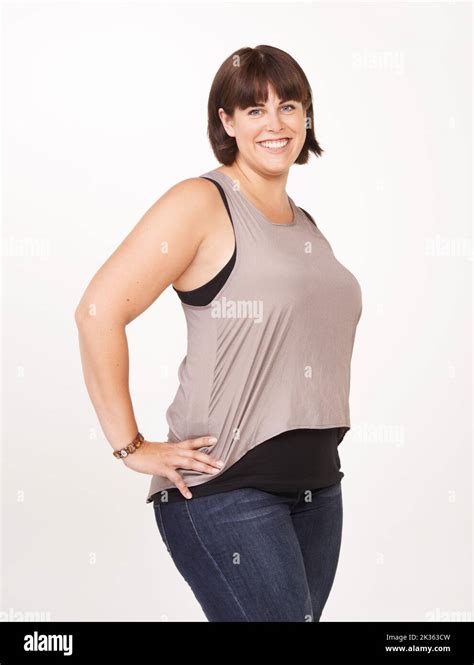 She knows who she is. Portrait of a pretty and curvy woman on a white ...