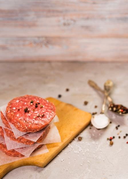 Free Photo | High angle patty burgers on a wooden board