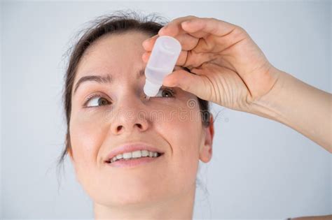 Caucasian Woman Dripping Moisturizing Drops into Her Eyes. Stock Photo ...