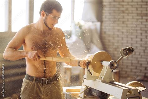Wood lathe .The naked Carpenter lathing wood to make product Stock