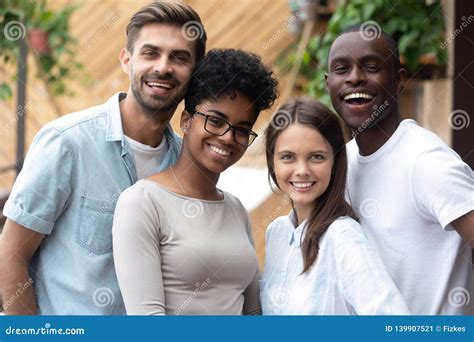 attractive happy multiracial people posing   camera stock