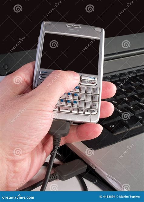 Sync Personal Digital Assistant with Laptop Stock Photo - Image of