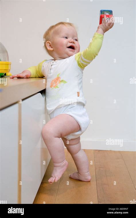 Baby showing a toy Stock Photo - Alamy