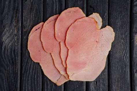 Premium Photo | Top view of slices of fresh ham on wooden table