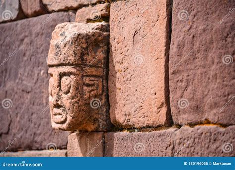 closeup   carved stone tenonv head embedded  wall