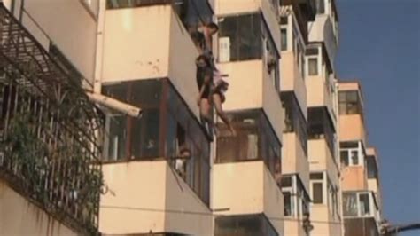 Couple rescued as they fall from balcony window - YouTube