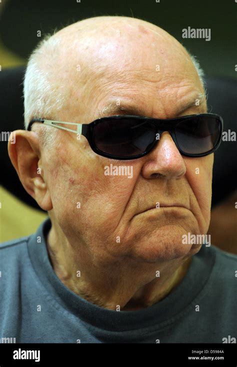 Accused Nazi death camp guard John Demyanyuk sits in a wheelchair as he ...