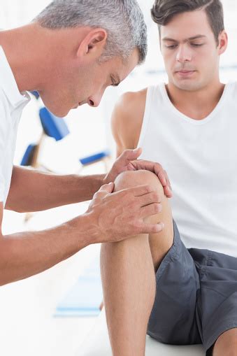 doctor examining  patient knee stock photo  image
