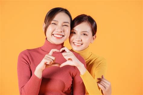 Premium Photo | Image of two young Asian woman on background