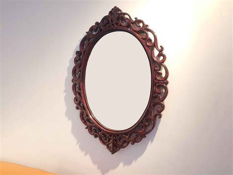 carved oval mirror