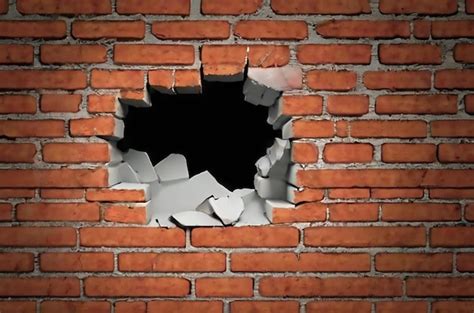 Una pared de ladrillo con un agujero en ella que dice un hoyo | Imagen ...