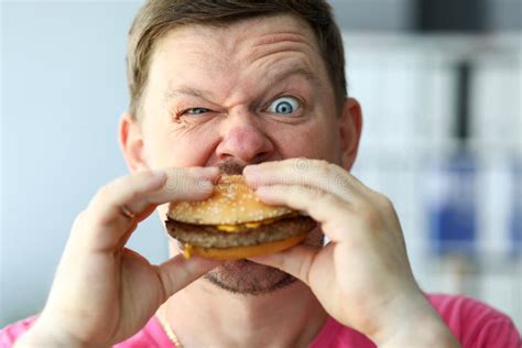 Funny Bearded Man with Idiot Facial Expression Eating Big Burger Stock ...