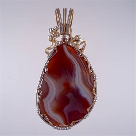 Stunning Lake Superior Agate pendants handcrafted in gold and silver