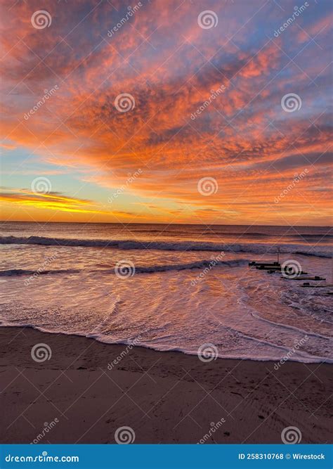 Vertical Shot of a Sandy Beach and the Sea Captured at a Beautiful