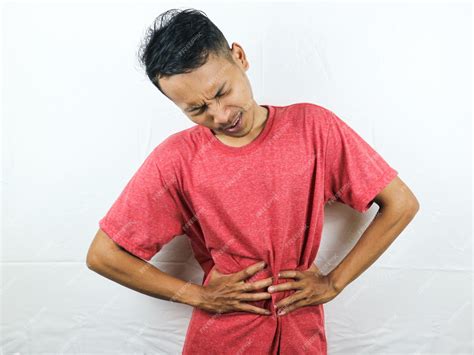 Premium Photo | Asian man holding his stomach feeling stomach pain