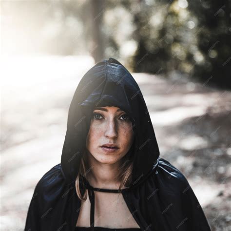 Free Photo | Beautiful charmer in hood in sunny woods