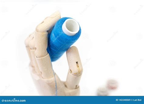 wooden hand  holding  coil  blue threads stock image image