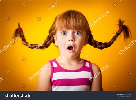 Surprised Little Girl Floating Pigtails Foto stock 1177972897