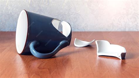 premium photo broken cup   office   wooden table