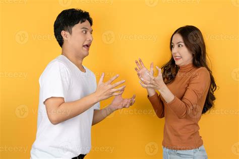 Asian couple arguing on yellow background 36410668 Stock Photo at Vecteezy