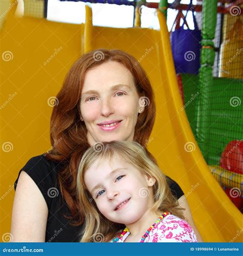 Daughter and Mother Together in Playground Slide Stock Photo - Image of