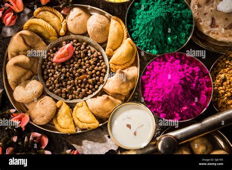 holi festival food with colours, indian festival holi, samosa, kachori, laddu, gujiya, palash ...