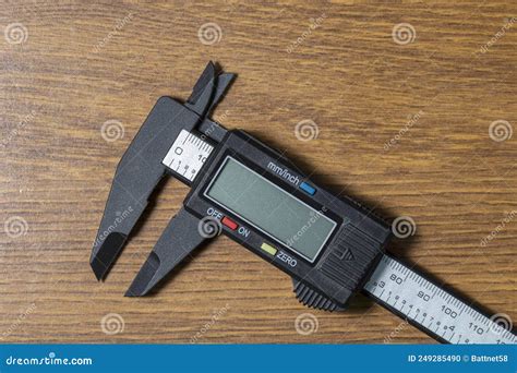 Caliper and Various Types of Fasteners on a Wooden Brown Background ...