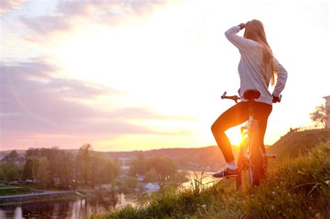 Premium Photo | Girl riding bike in sunset